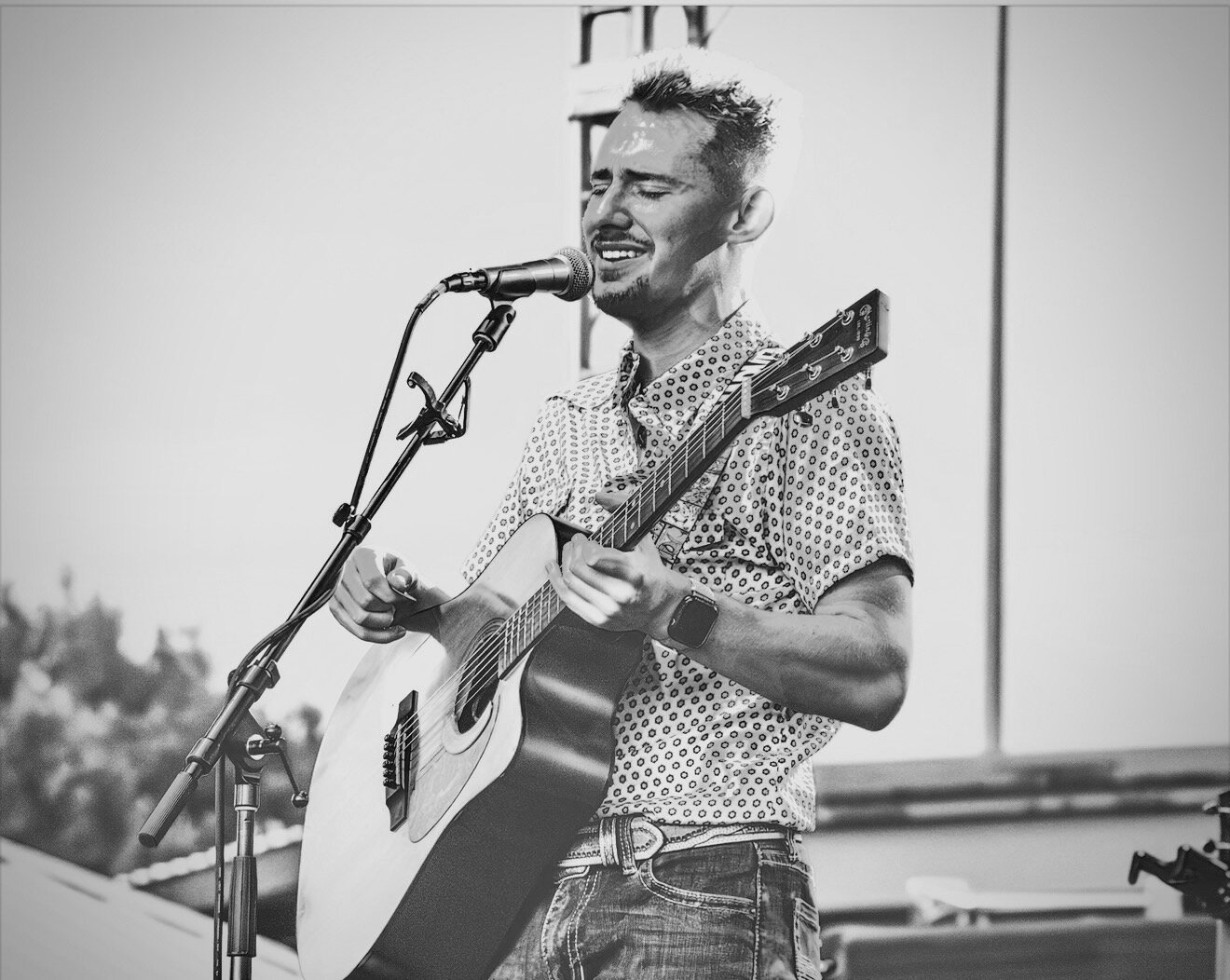 Black and white portrait of Dillon Leggett singing outdoors
