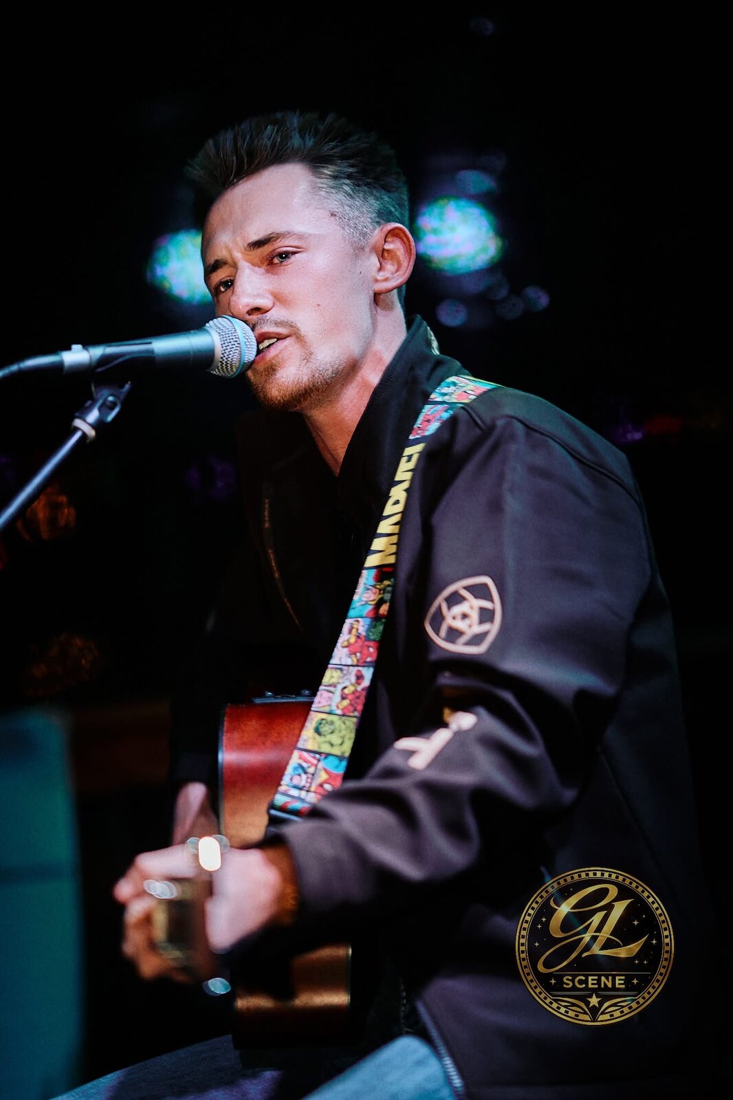 Close-up of Dillon Leggett singing into a microphone